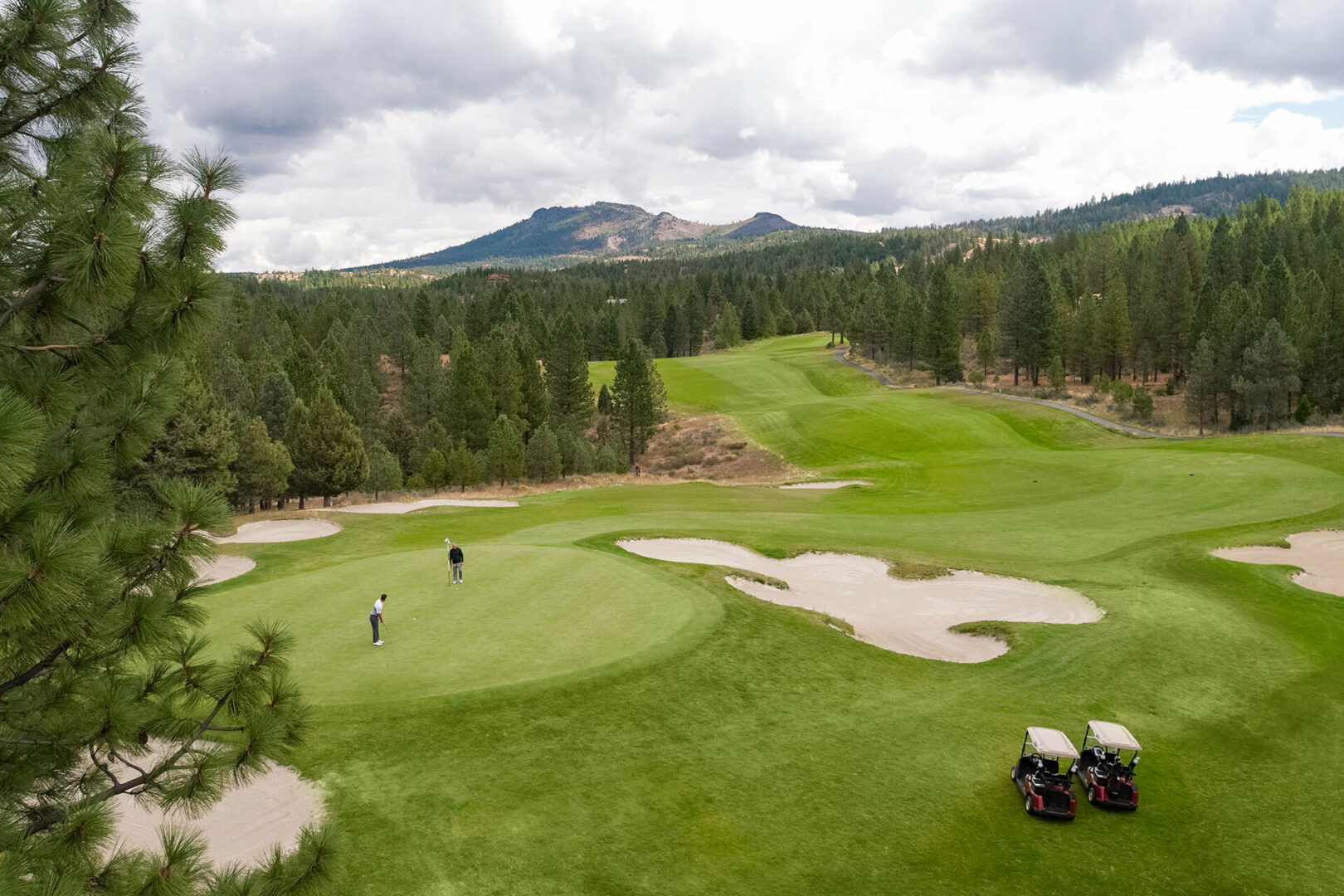 Golfers on the 18th green of Nakoma Resort's championship golf course known as The Dragon